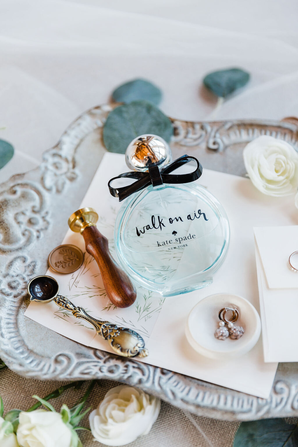 Artistic shot of the bride's perfume bottle, a subtle yet significant detail that adds to the sensory memories of the wedding day