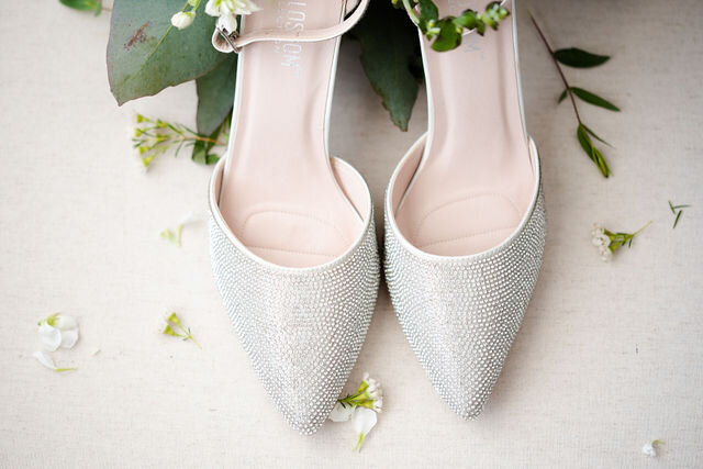 A pair of white heels