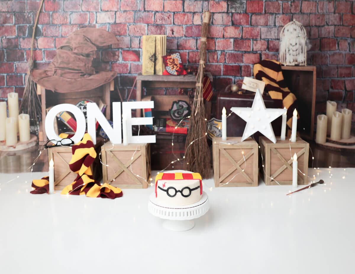 Fun Harry Potter birthday cake smash session in Rochester, NY, featuring wizard decorations.