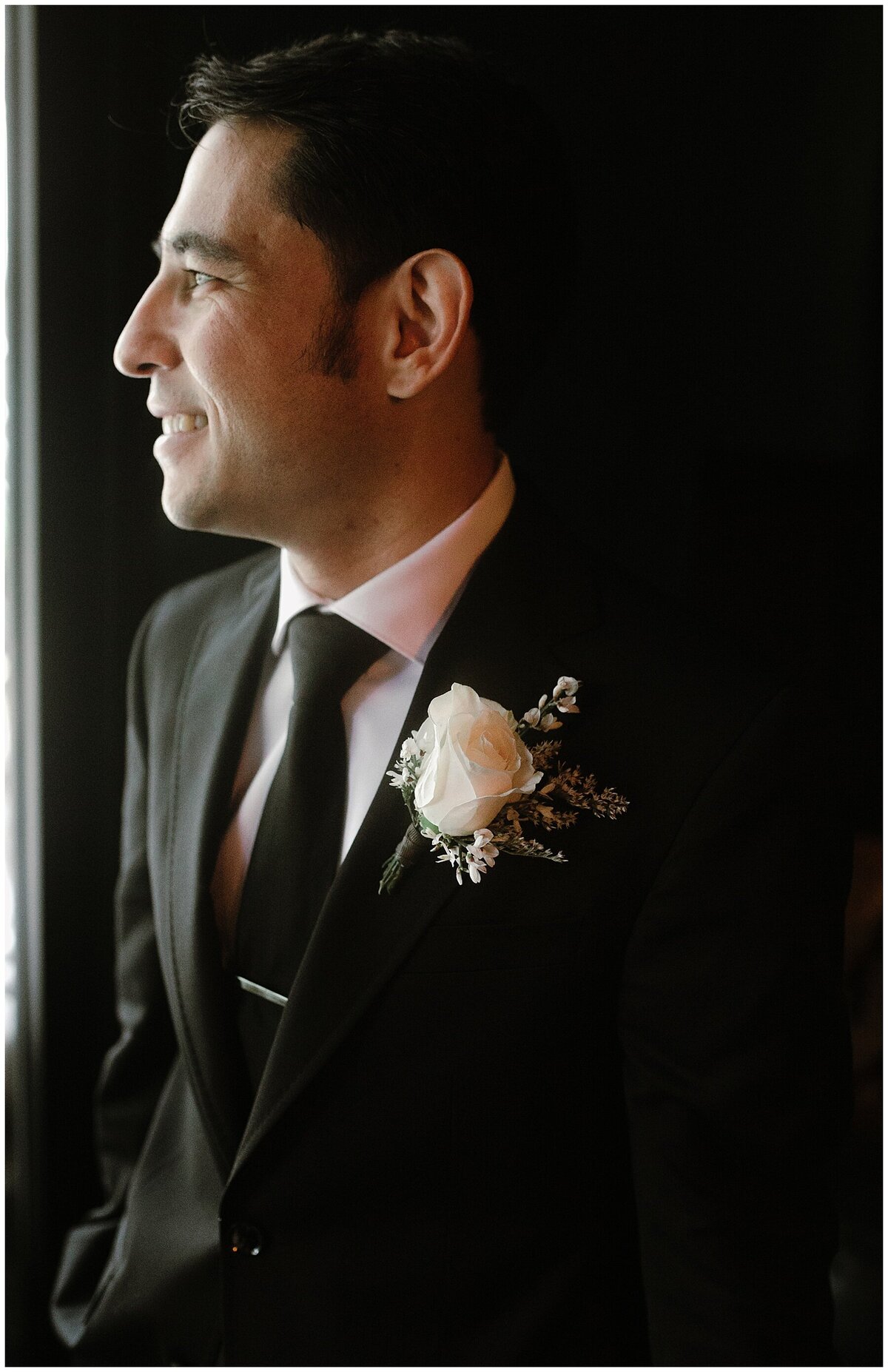 Groom looking out the window at Hotel Saint Cecilia Wedding