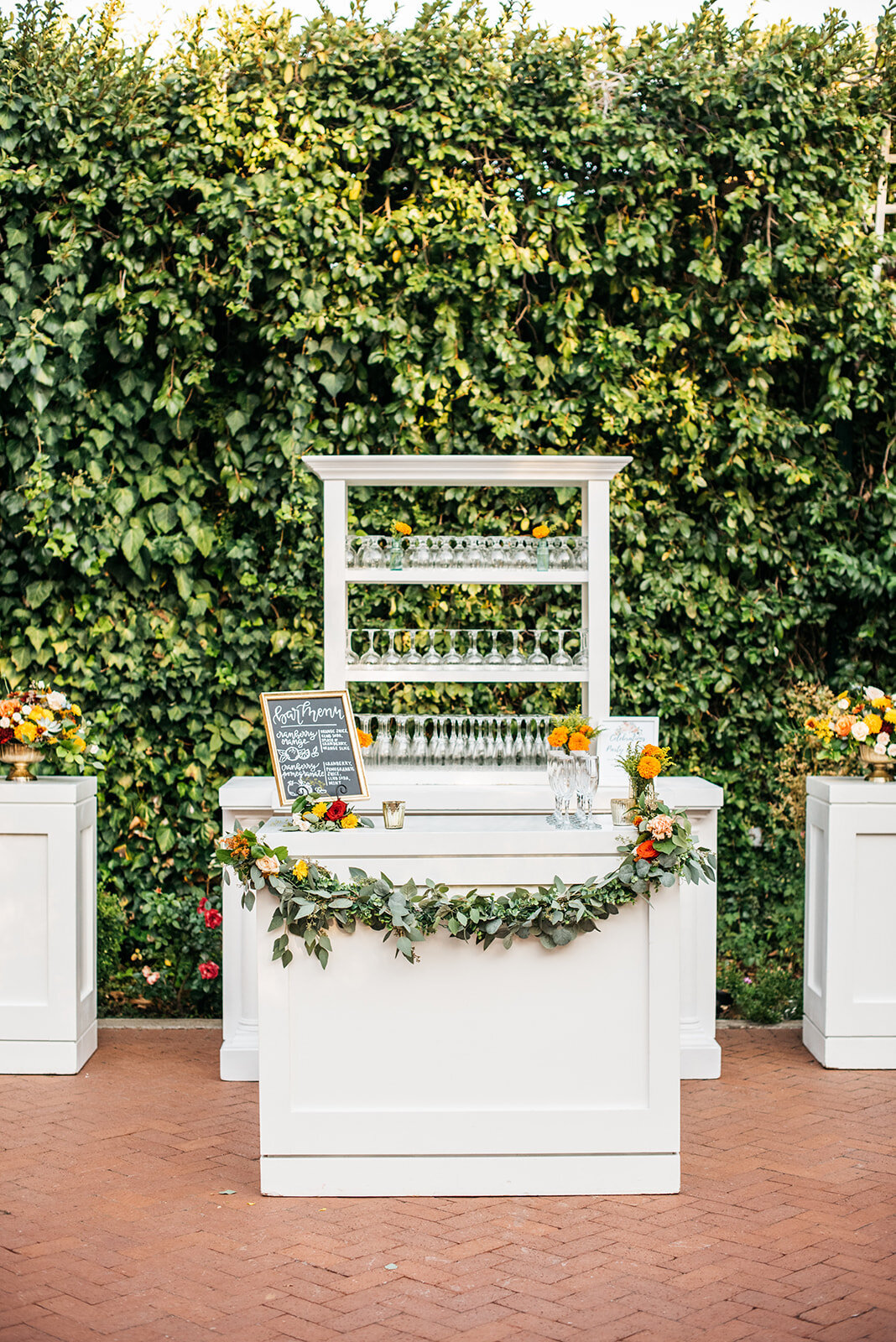 This elegant white bar display is the perfect addition to the cascading ivy wall in the Gardens Courtyard.