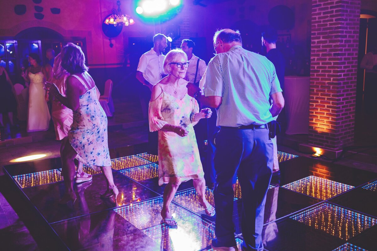 Older couple dancing at reception at wedding in Riviera Maya