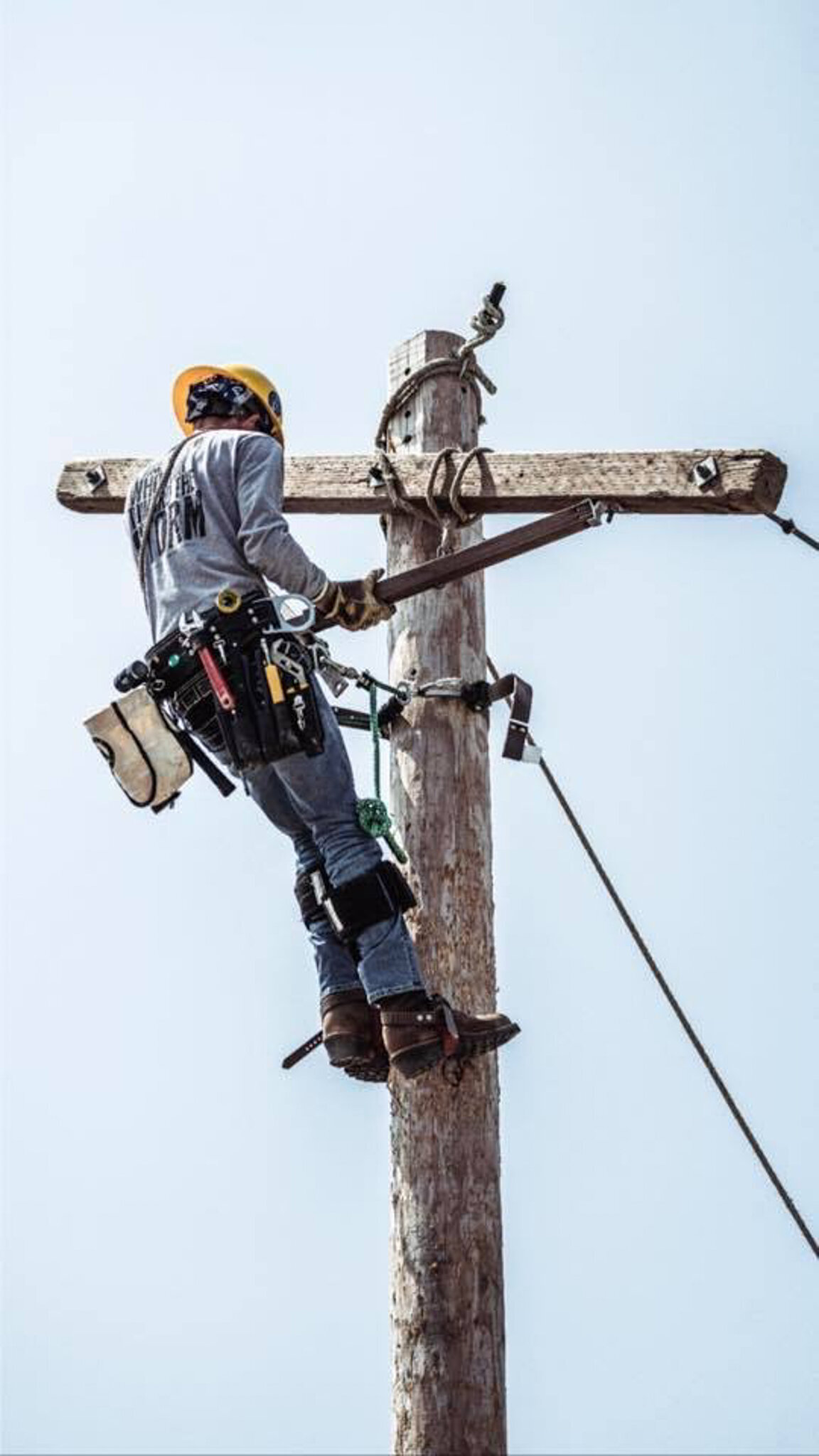 photo of Allie's husband climbing an electrical pole