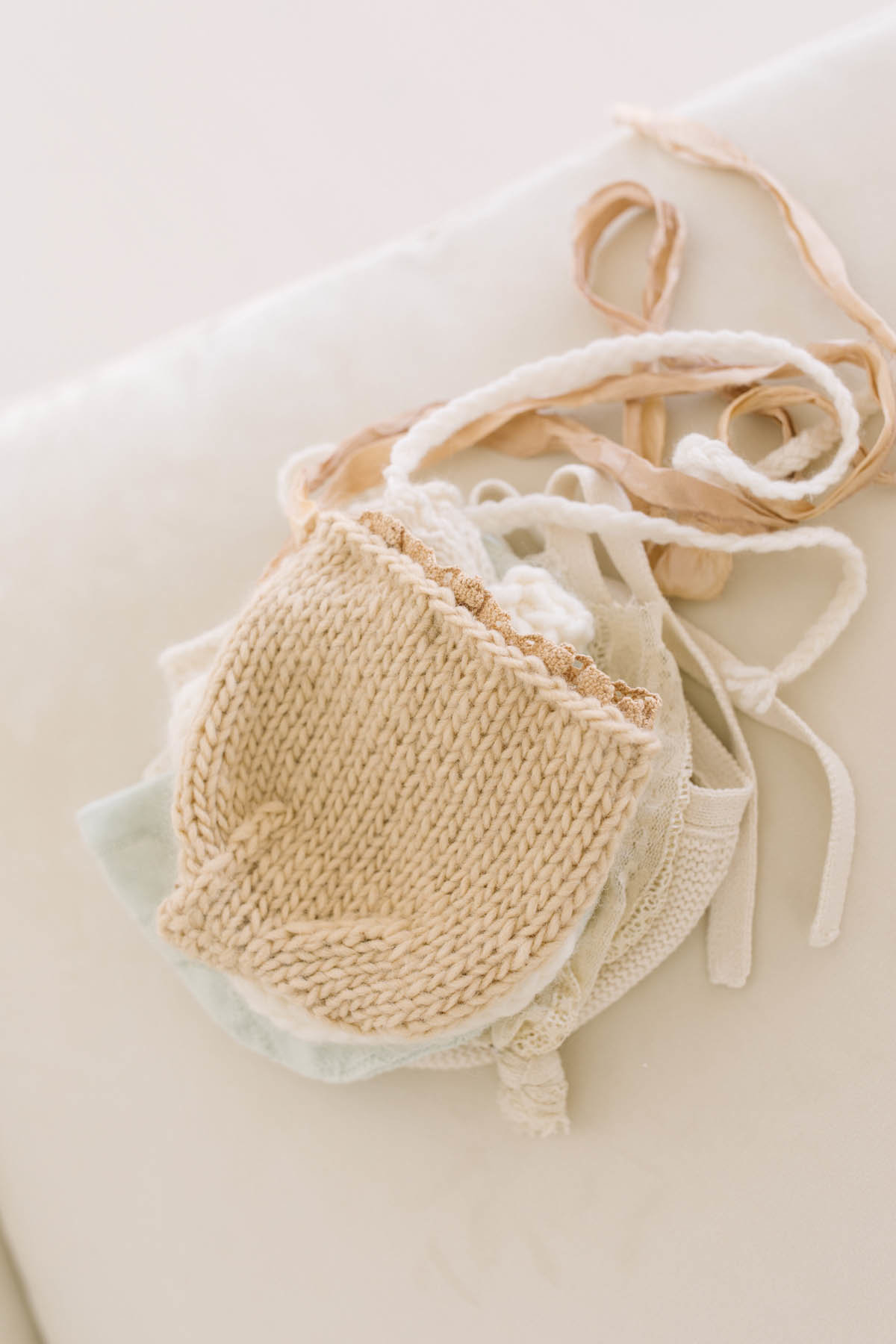 Laurie Baker has a large collection of baby bonnets and hats for her newborn sessions