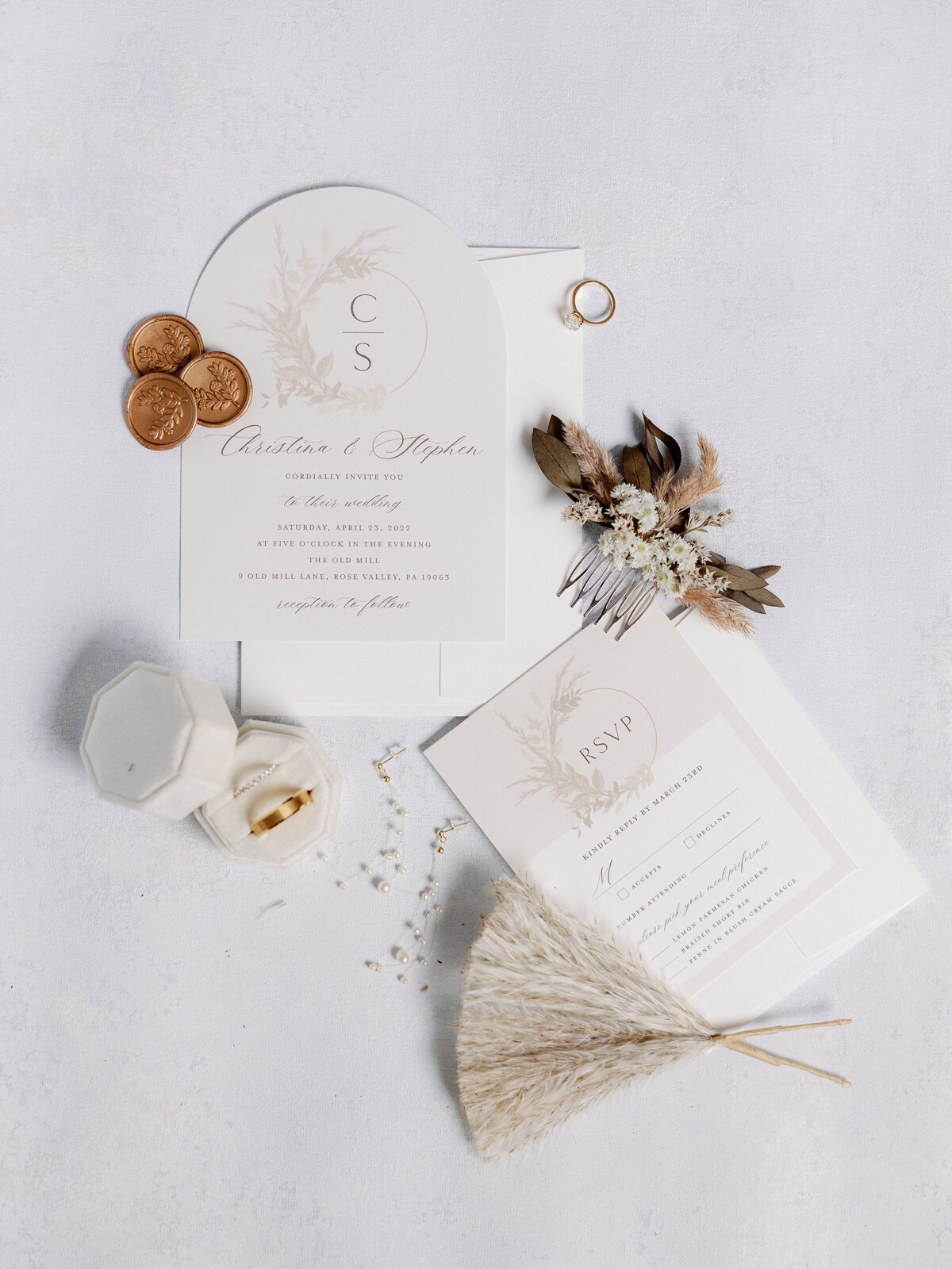 A top down view of a wedding invitation and bridal details