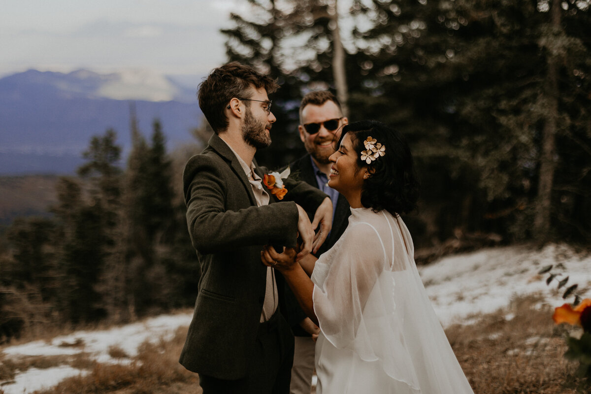 bride and grooms first kiss on Sandia Mountain after their elopement