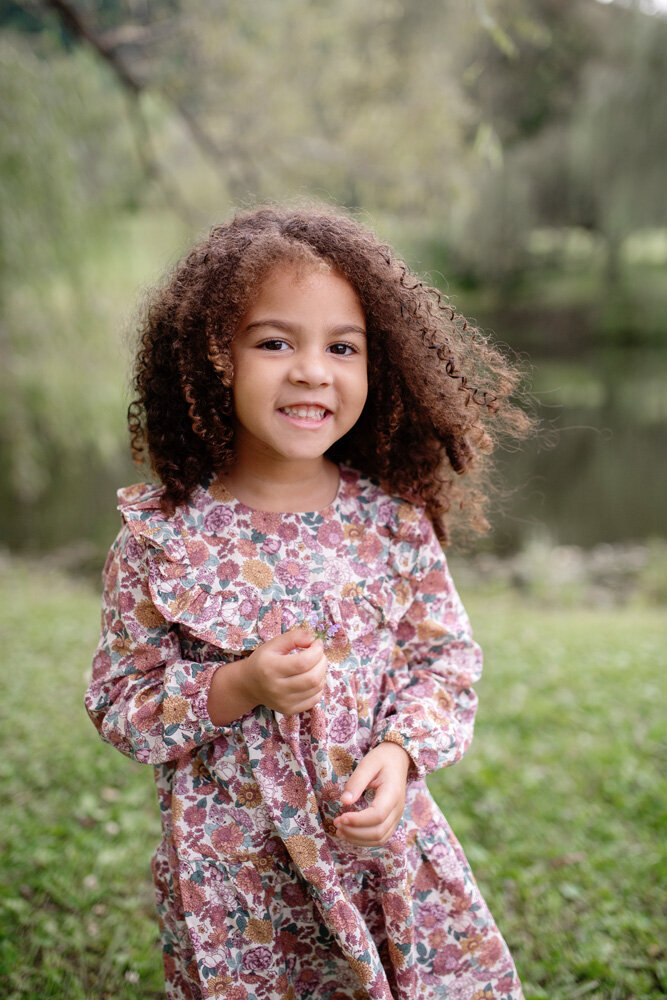 Family session of little girl in floral dress