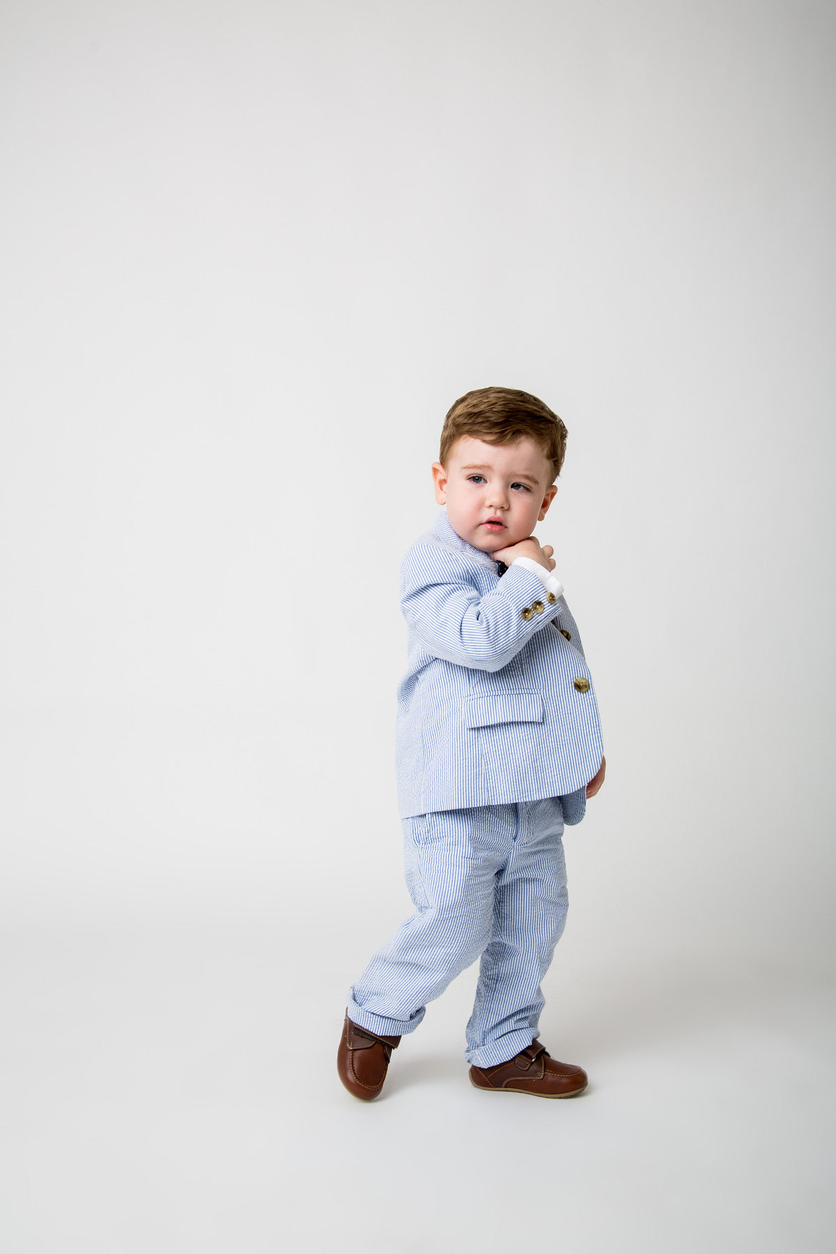 photo of baby toddler wearing blue and white pinstripe suit taken by San Antonio Photographer Expose The Heart Photographer