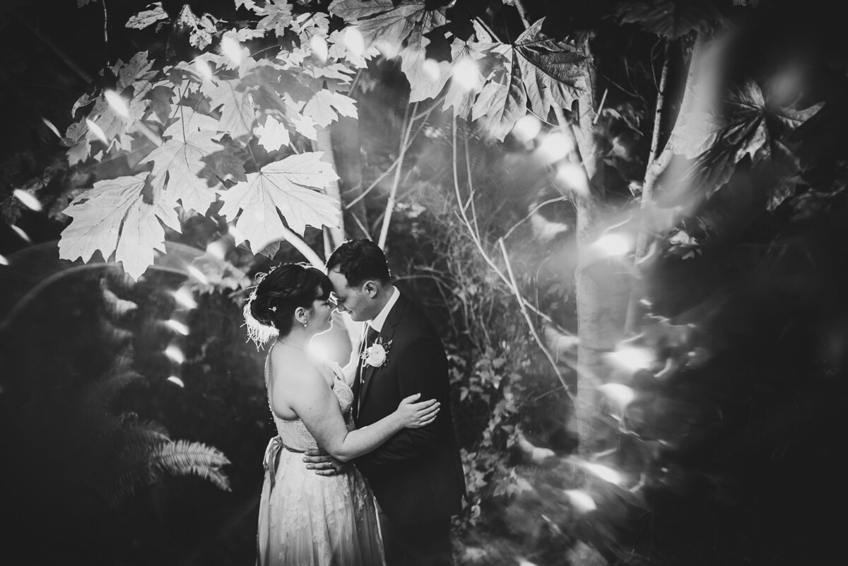 Couple with heads together in trees in black and white
