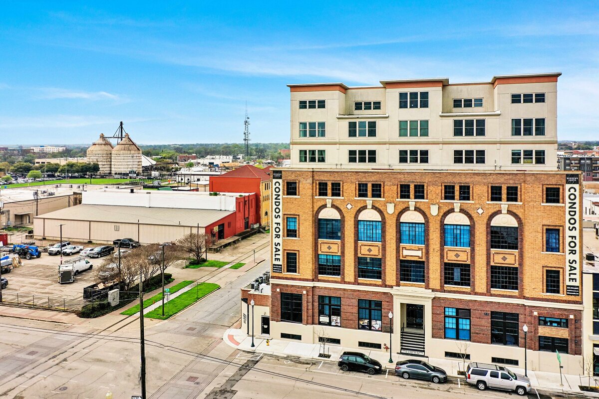 Front view of the whole building complex at this one-bedroom, one-bathroom vintage industrial condo with Smart TV, free Wi-Fi, and washer/dryer located in downtown Waco, TX.