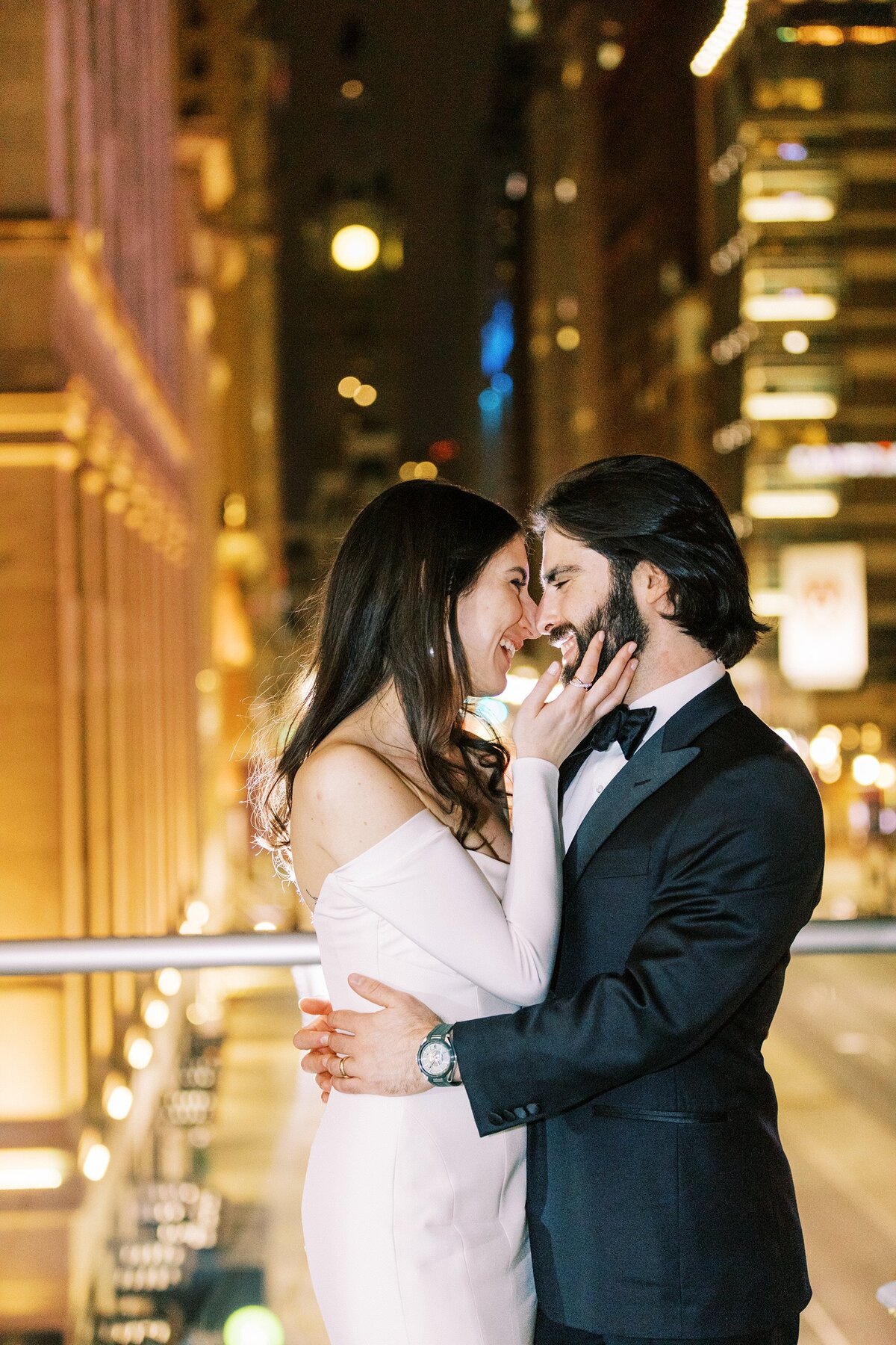 Bride and groom embracing on city rooftop