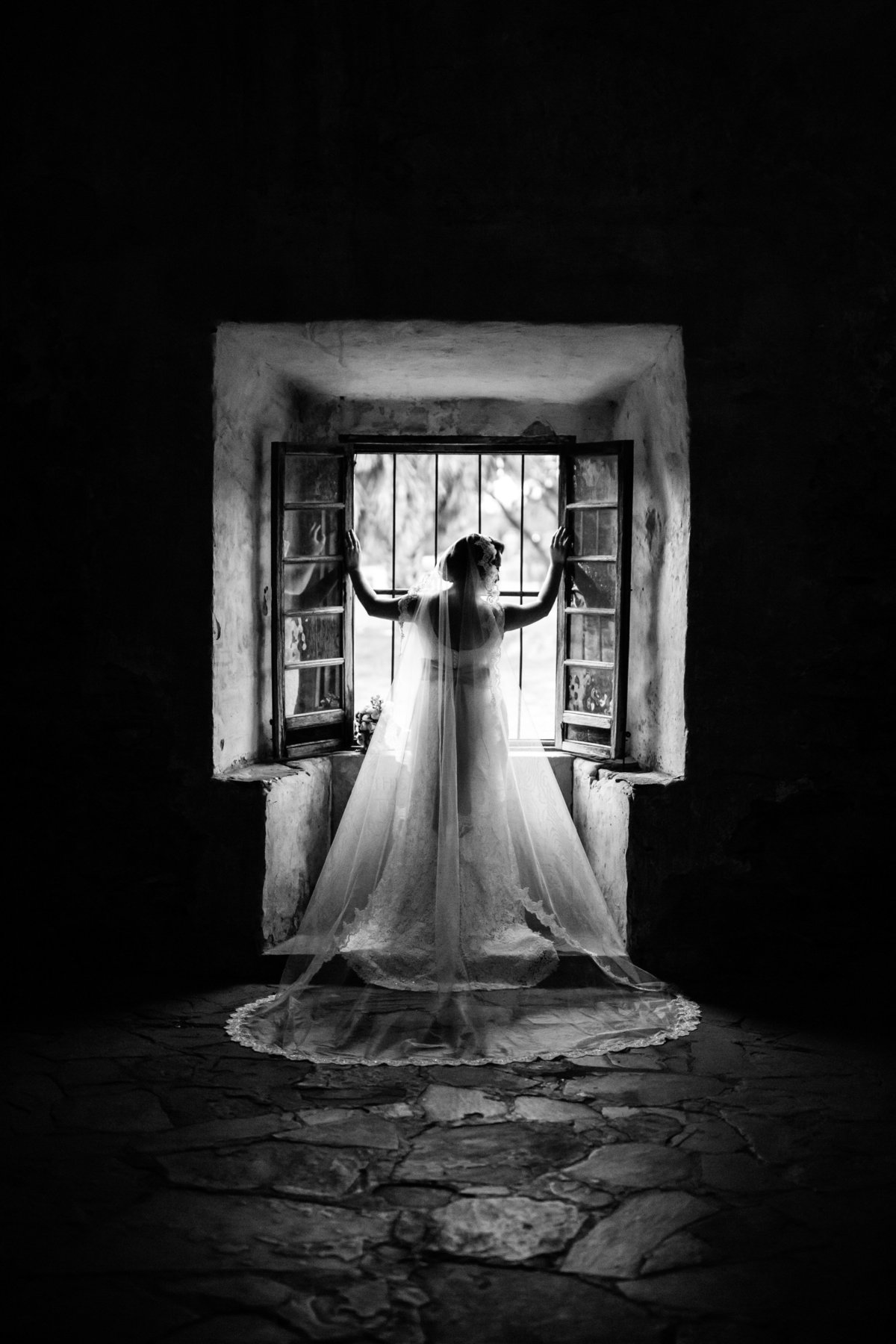 bride inside mission San Jose for her bridal in front of window