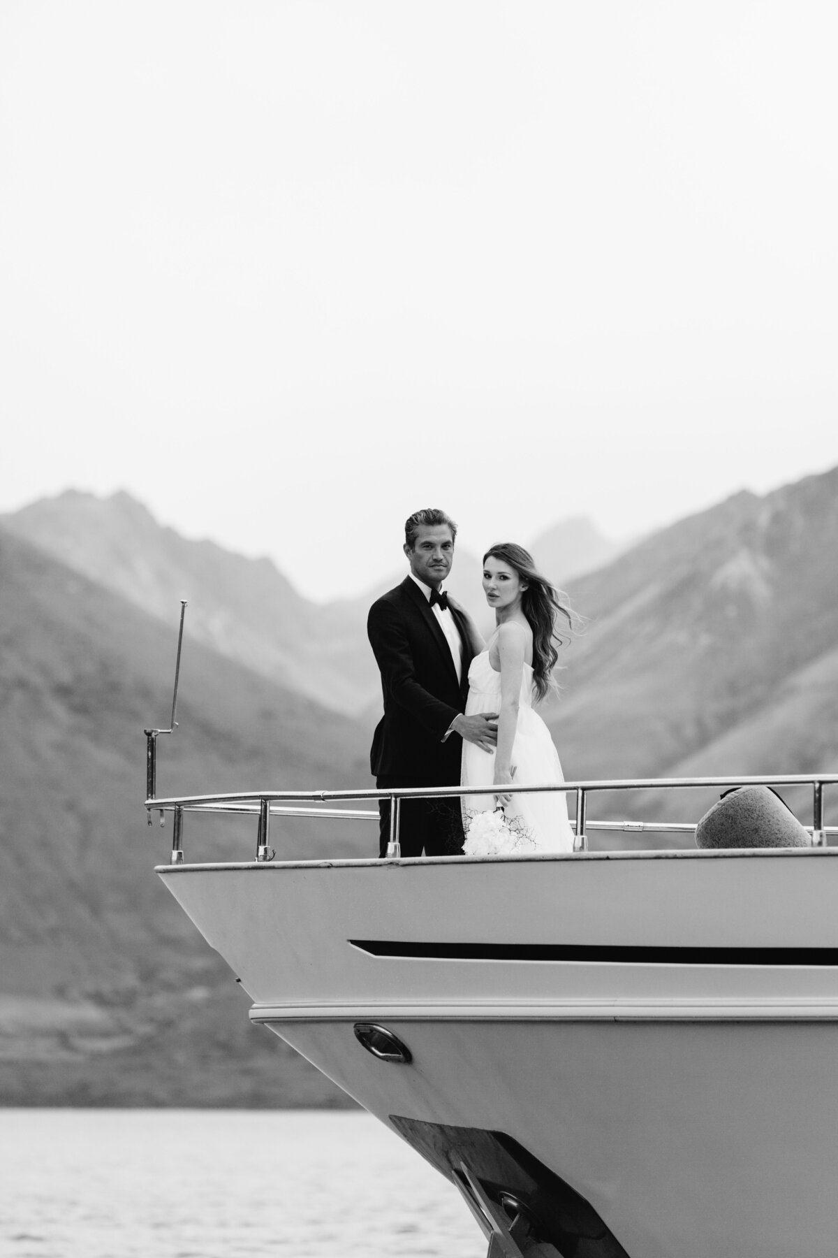 The Lovers Elopement Co - bride and groom on boat in Queenstown lake, New Zealand