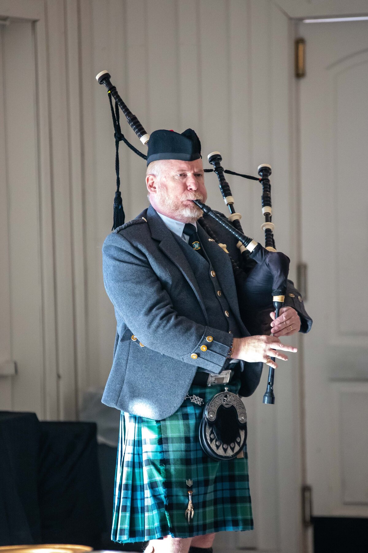 bagpipe player stands in sunlight  at wedding ceremony at Milestone Georgetown Texas wedding
