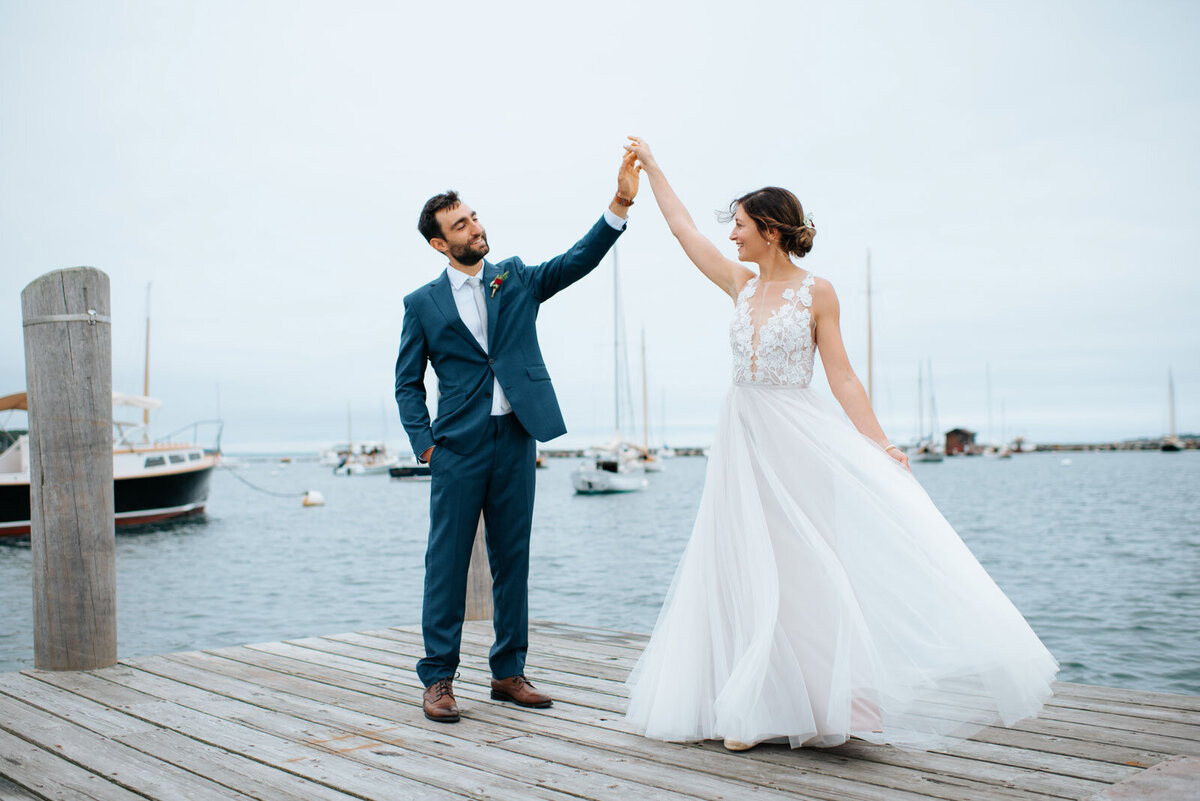 bride and groom dancing on dock at martha's vineyard wedding beach