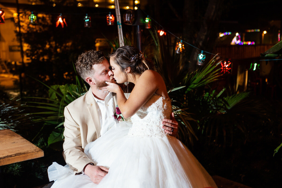 Charleston Wedding Photographer Night kiss with bride and groom at Taco Boy Folly Beach