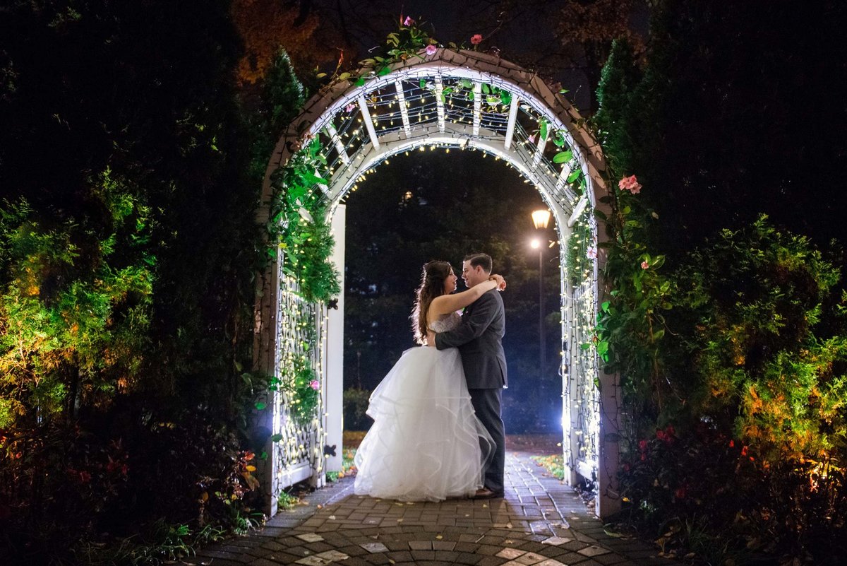 Bride and groom under the arch at Fox Hollow