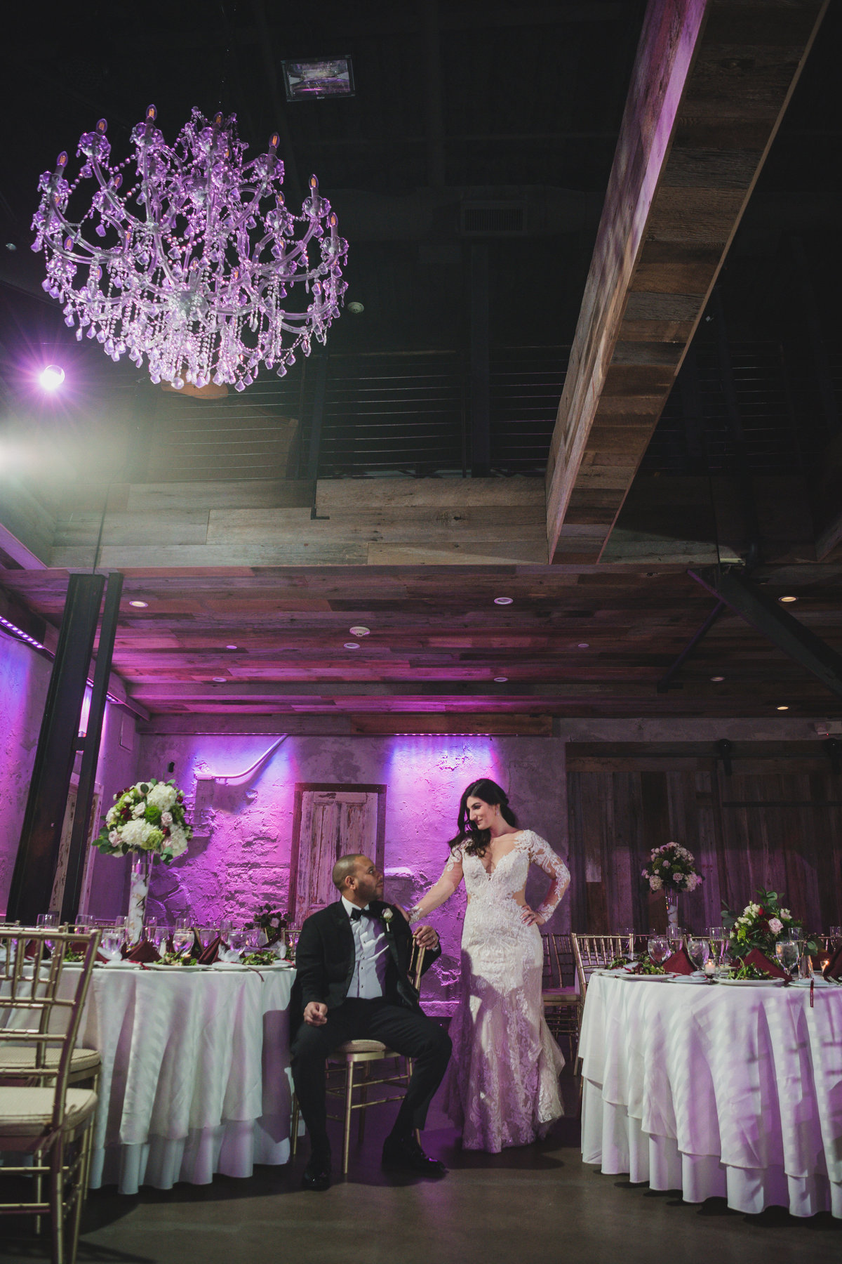 photo of bride and groom posing and looking at each other in wedding reception at The Loft by Bridgeview