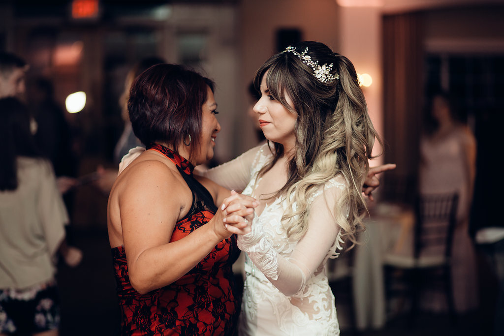 Wedding Photograph Of Bride Dancing With a Woman In Red Dress Los Angeles