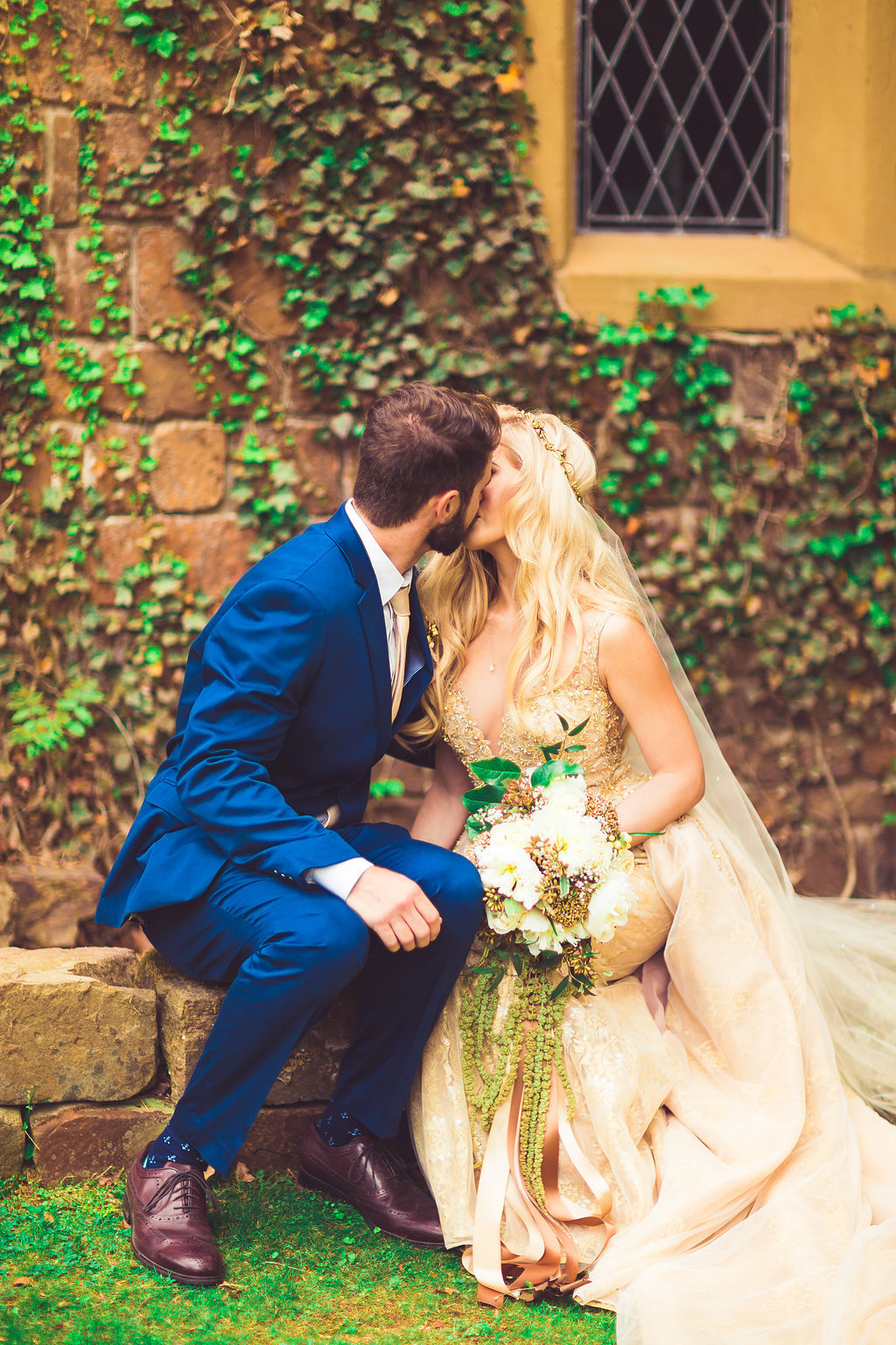Wedding Photograph Of Bride in Her Dress and Groom in His Blue Suit Kissing Los Angeles