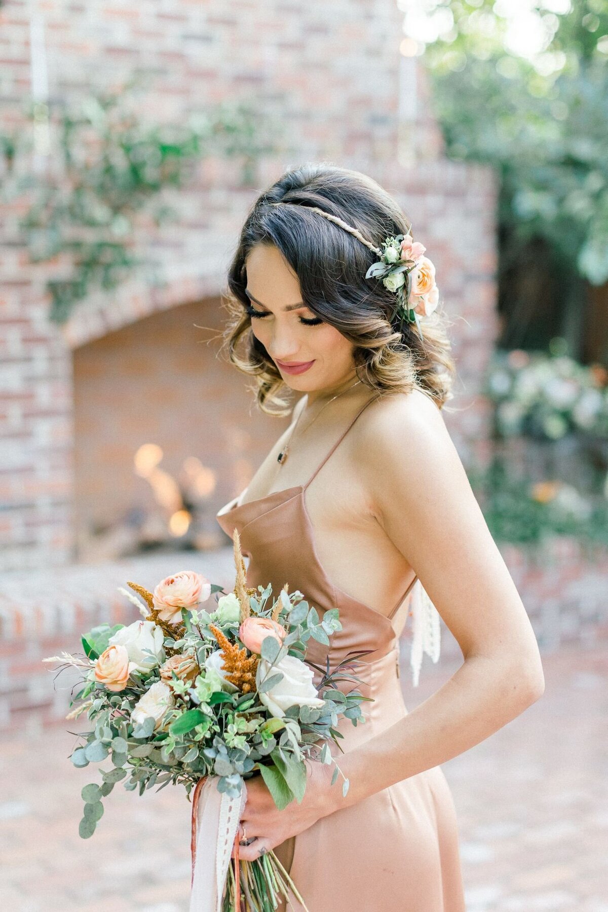 Not only does the bridesmaid hold a stunning bouquet of flowers but she wears a minimal flower crown.