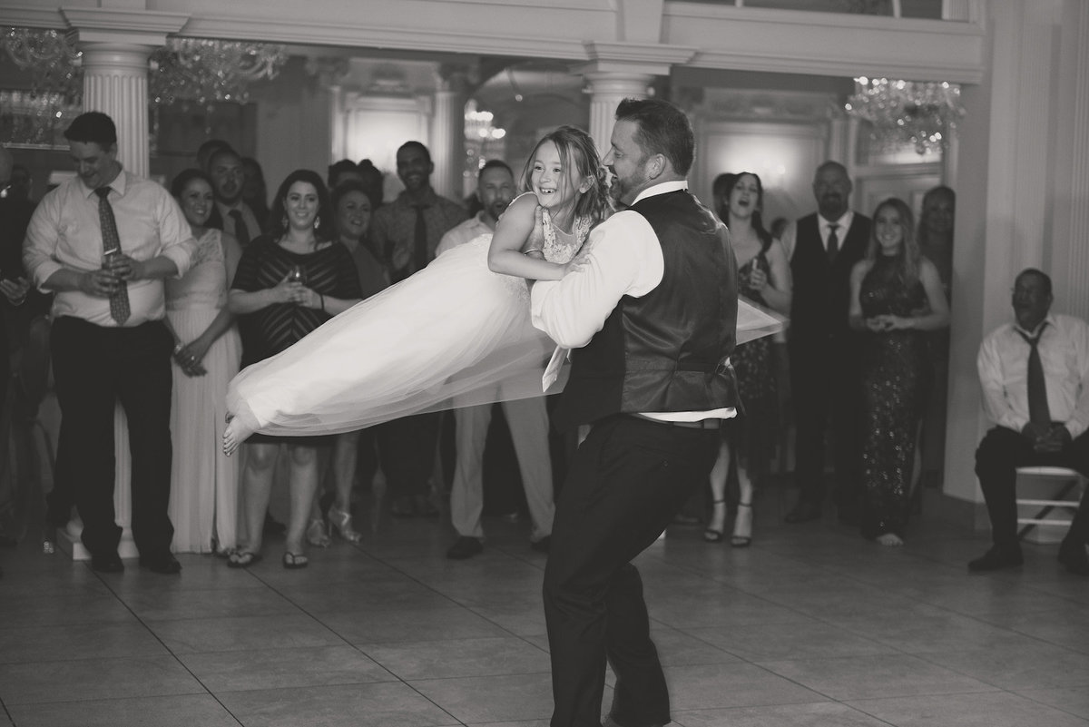 black and white photo of bride and groom first dance during wedding reception at Lombardi's on the Bay