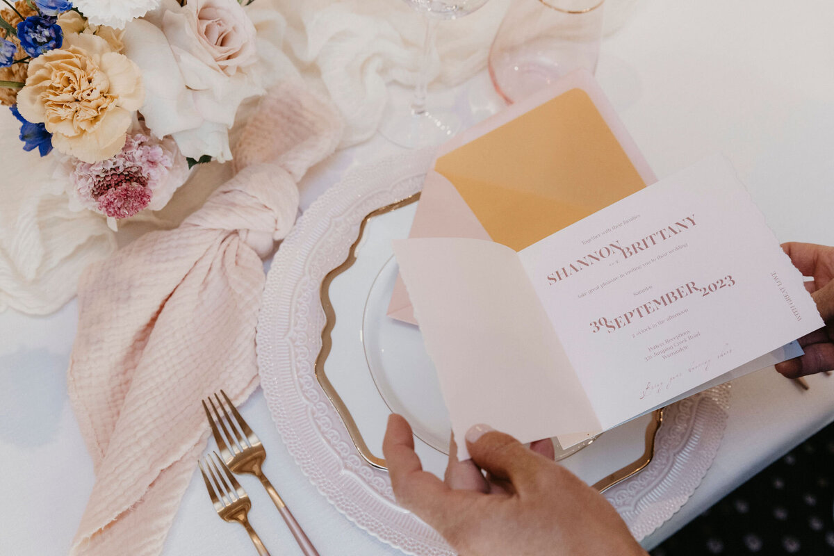 Peach pink sewn wedding invitations