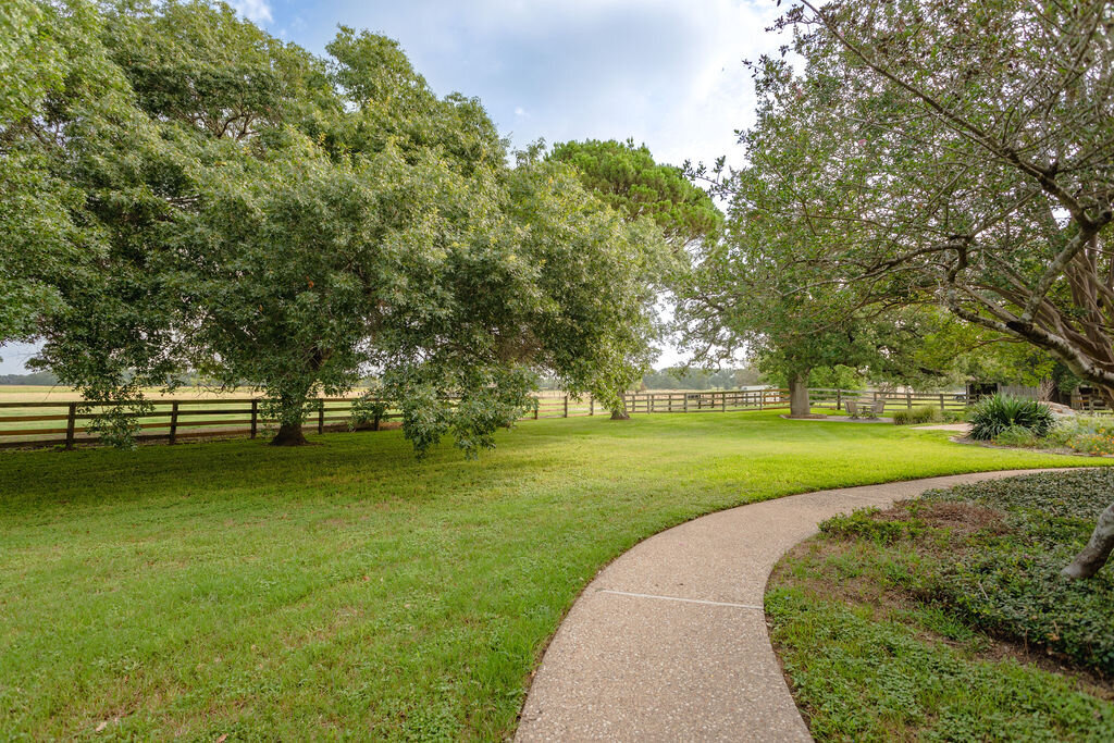 Spacious yard and view of the beautiful property at this 5-bedroom, 4-bathroom vacation rental house for 16+ guests with pool, free wifi, guesthouse and game room just 20 minutes away from downtown Waco, TX.
