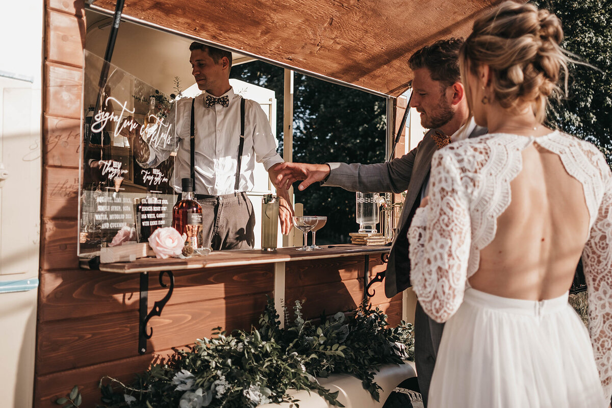 bartender talking with bride and groom