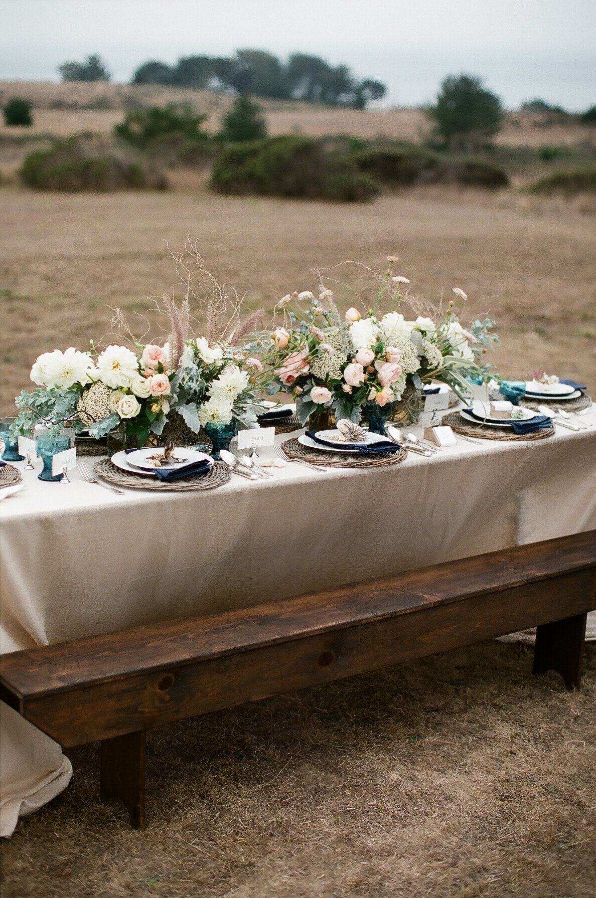 long table with flowers in peach and white
