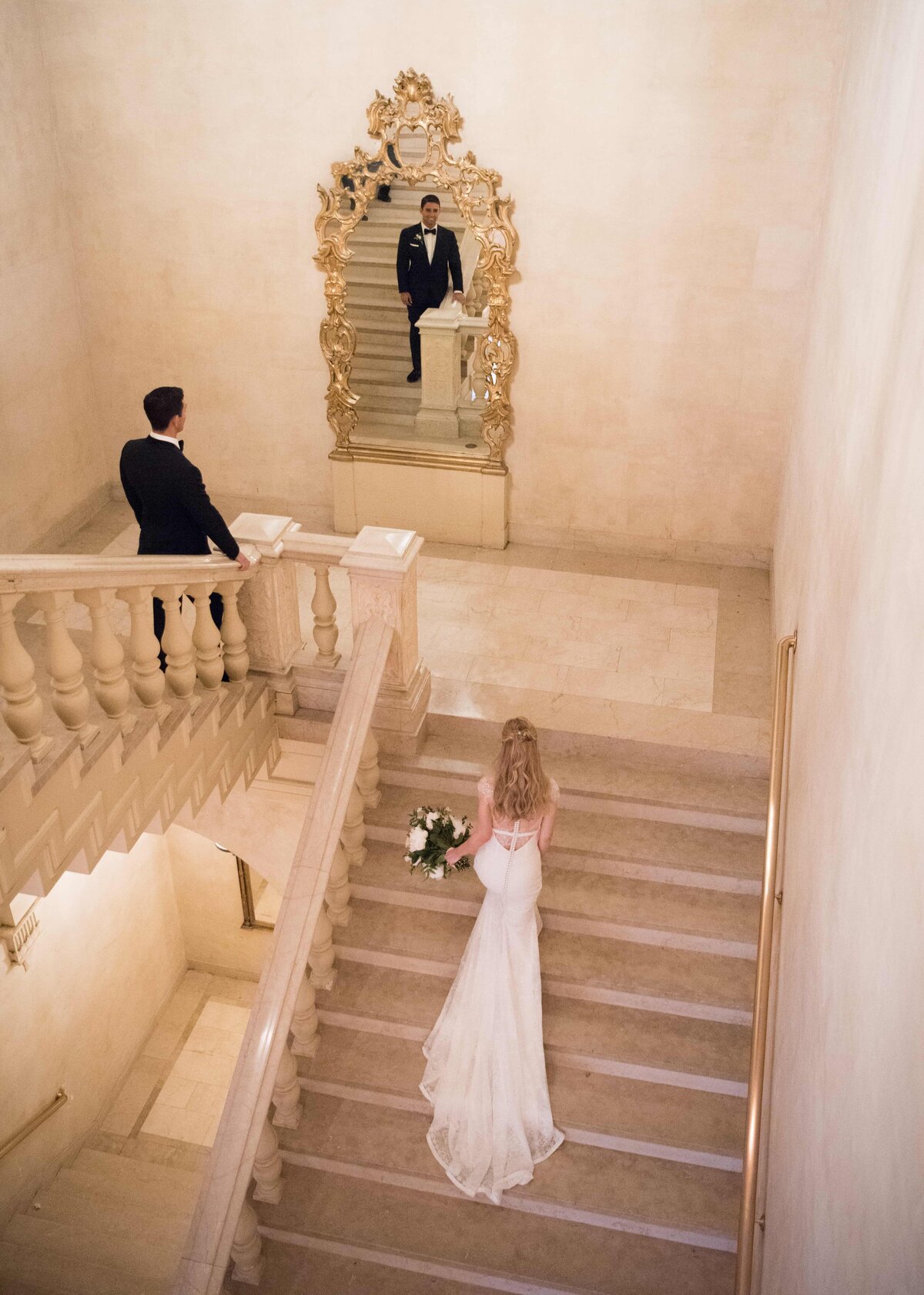 bride and groom first look by staircase