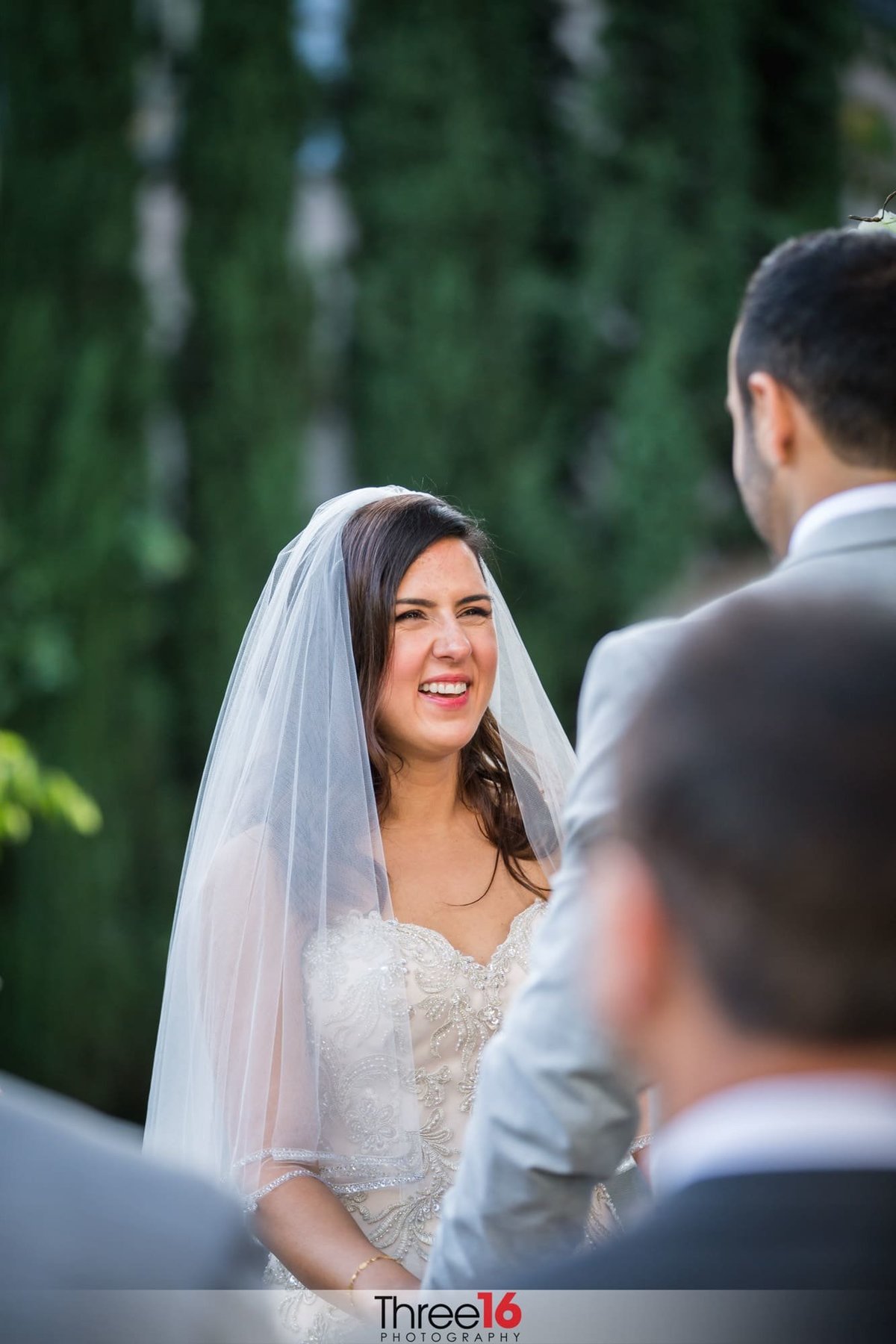 Bride smiles big at her Groom during the ceremony