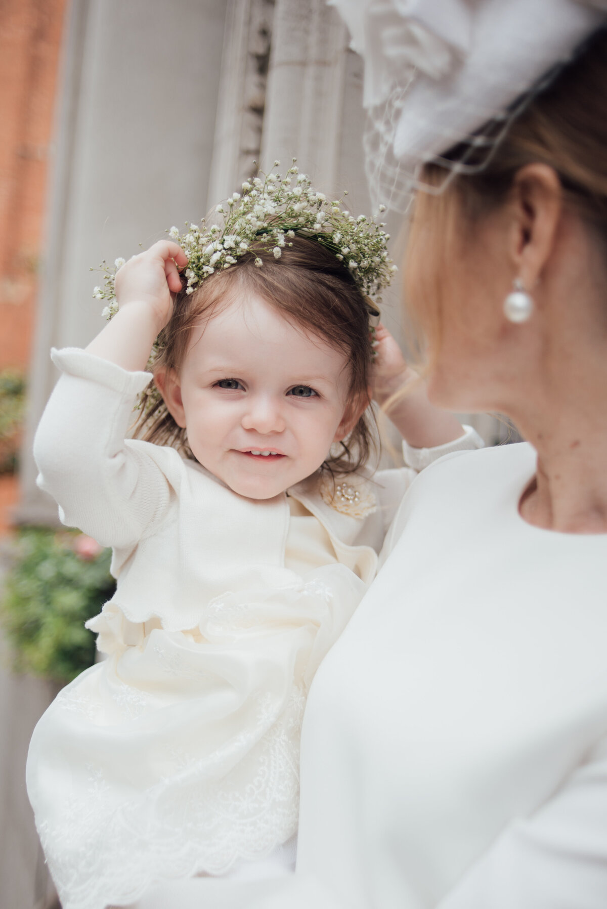 A young girl being held by her mother  taken by London Wedding Photographer Liberty Pearl