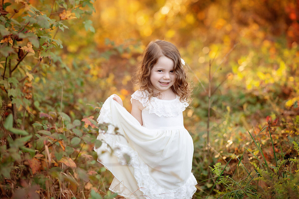 Family session of little girl in a white dress