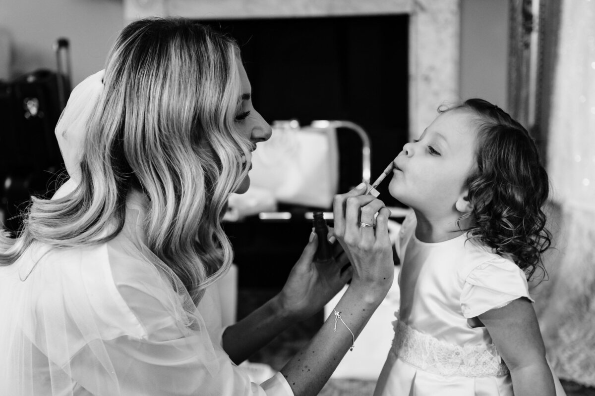 Brid applies lipgloss to her daughter