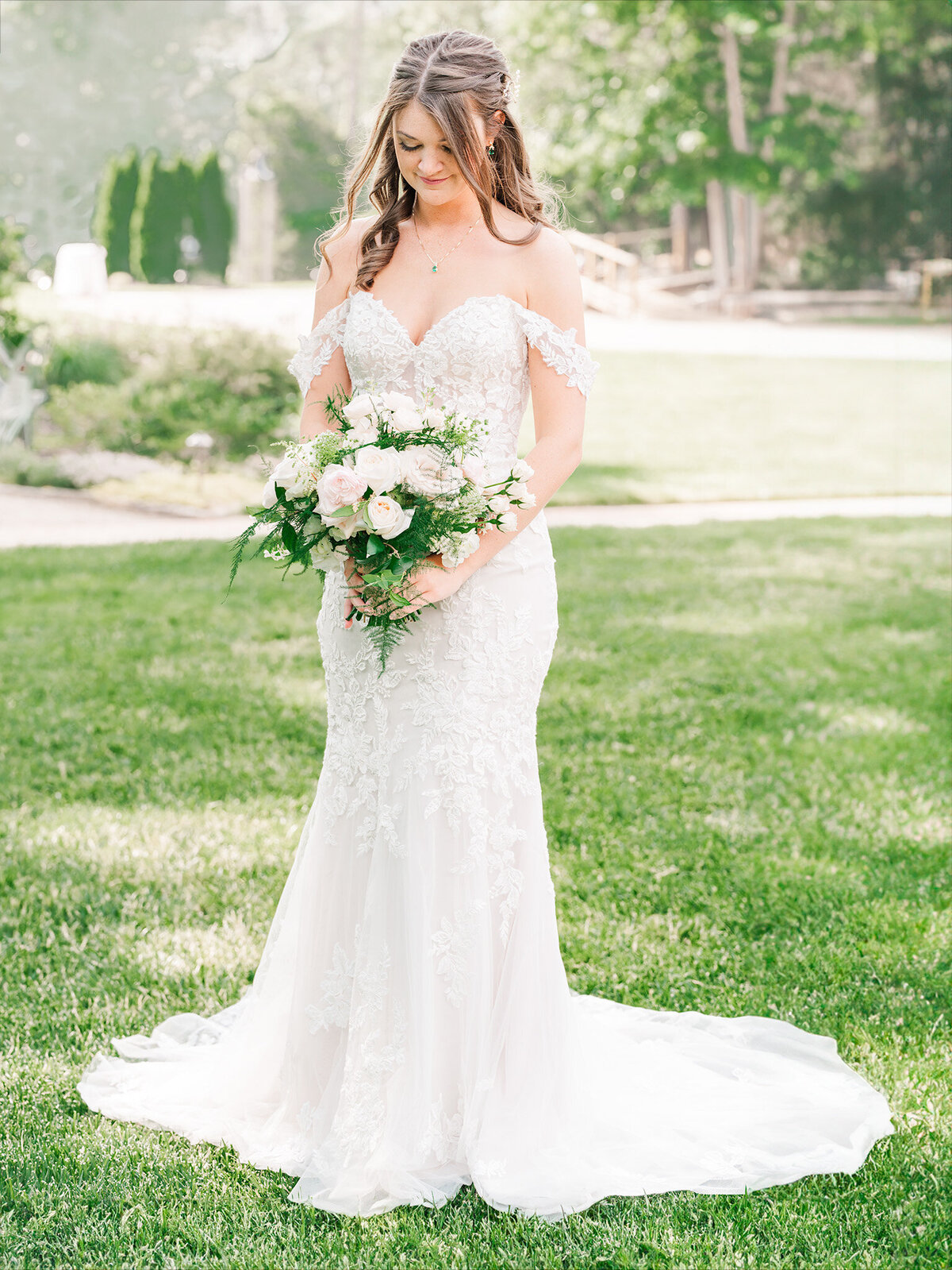 A brunette bride holding her wedding bouquet at the Angus Barn for her bridal portrait session with JoLynn Photography, a North Carolina wedding photographer