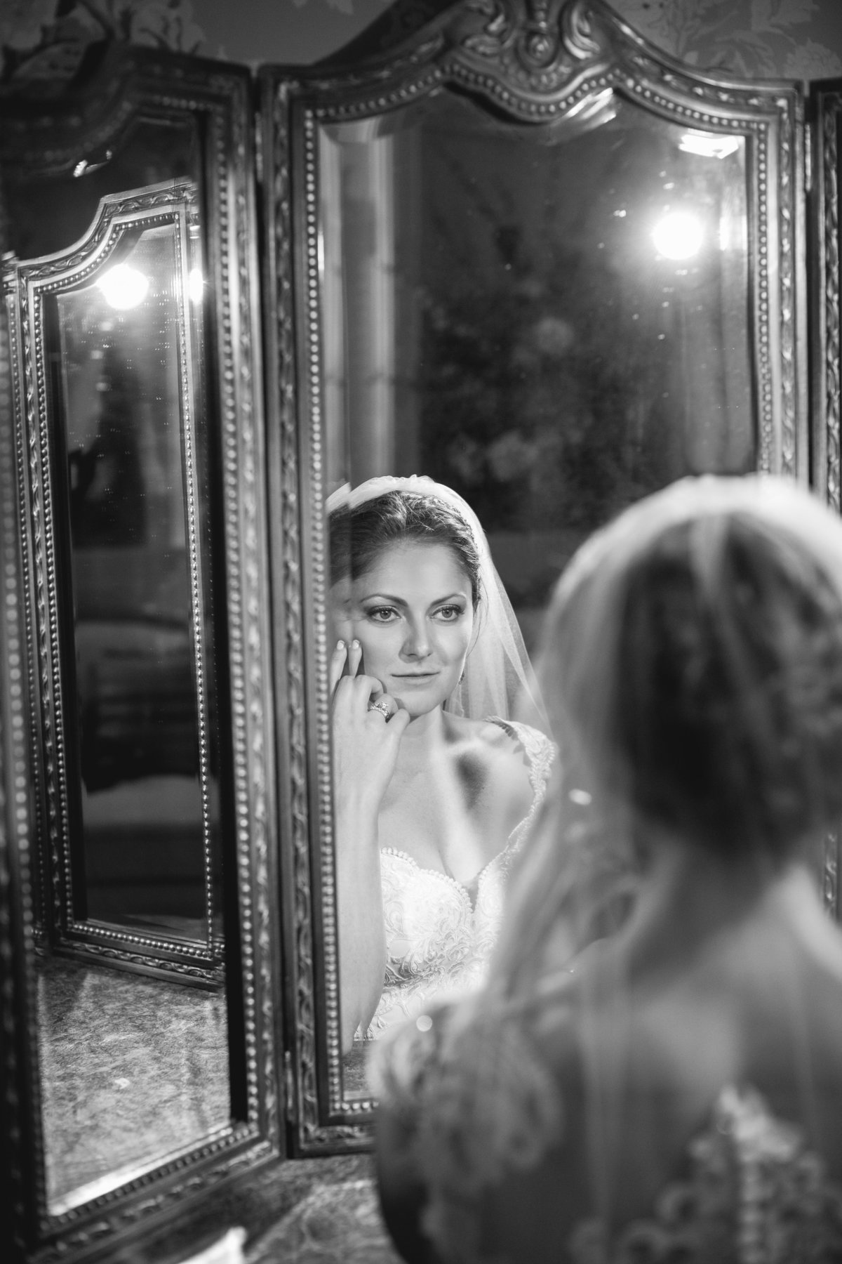 bride looking in mirror at ashford estate wedding