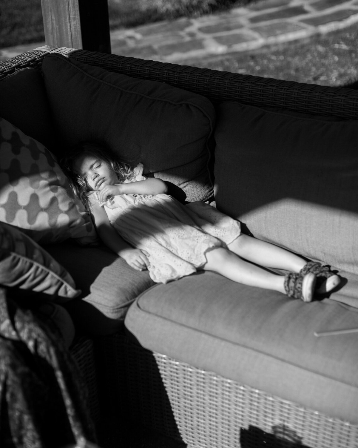Flower girl naps after the ceremony on a couch