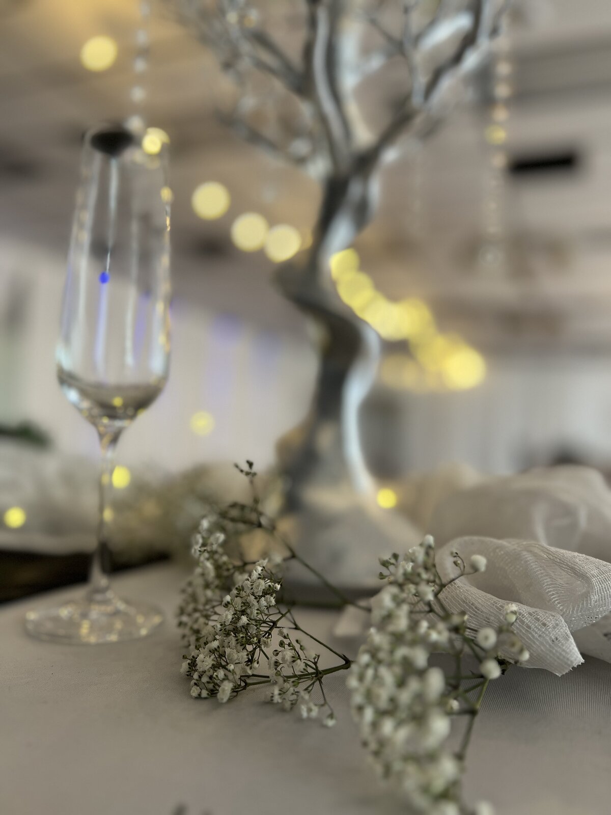 Elegant manzanita tree centerpiece, part of our inclusive decor package, adorned with aesthetic glass orbs and fresh floral baby's breath flowers - Adding a touch of sophistication to your event
