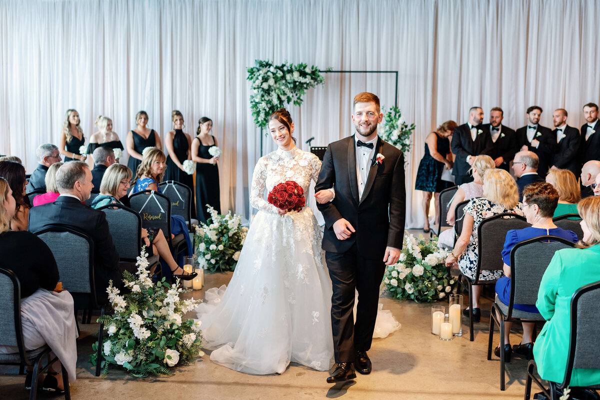 Bride and groom walking down the aisle at  Pier 21 in Halifax, Nova Scotia