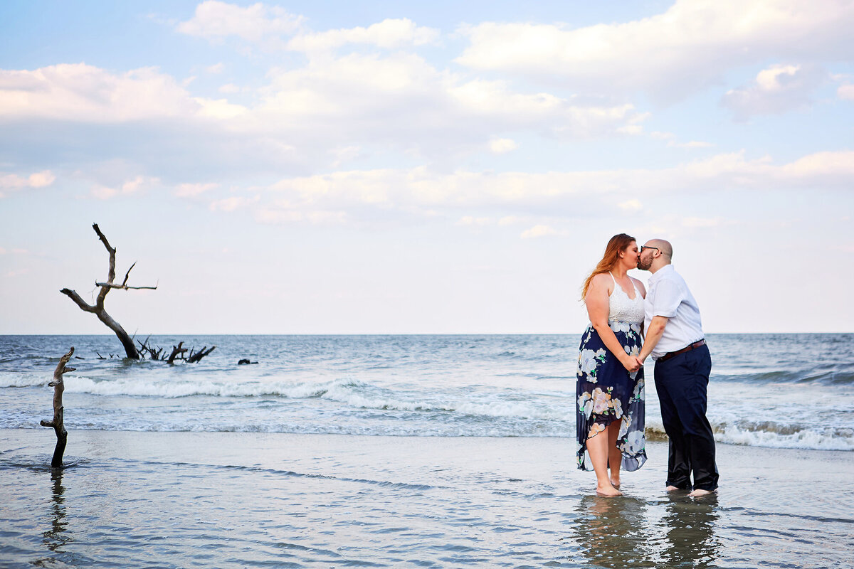 Bride and groom kiss in the water at Hunting Island State Park Charleston Wedding Photographer
