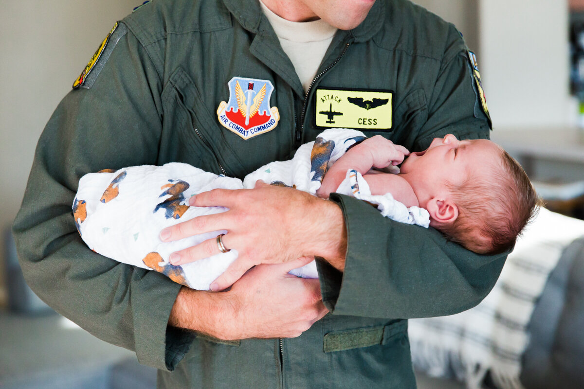 dad holding baby in Scottsdale lifestyle newborn photography session