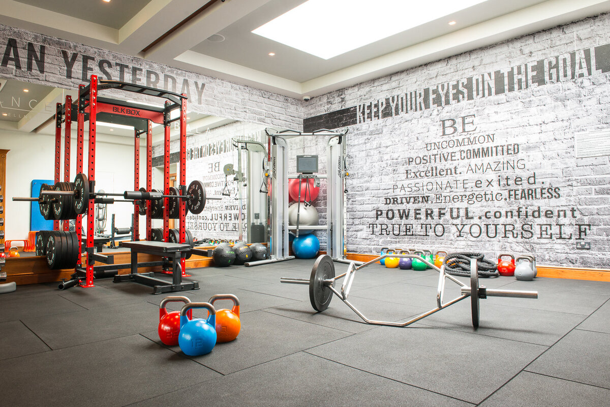 Interior of gym with grafitti walls and colourful kettle bells