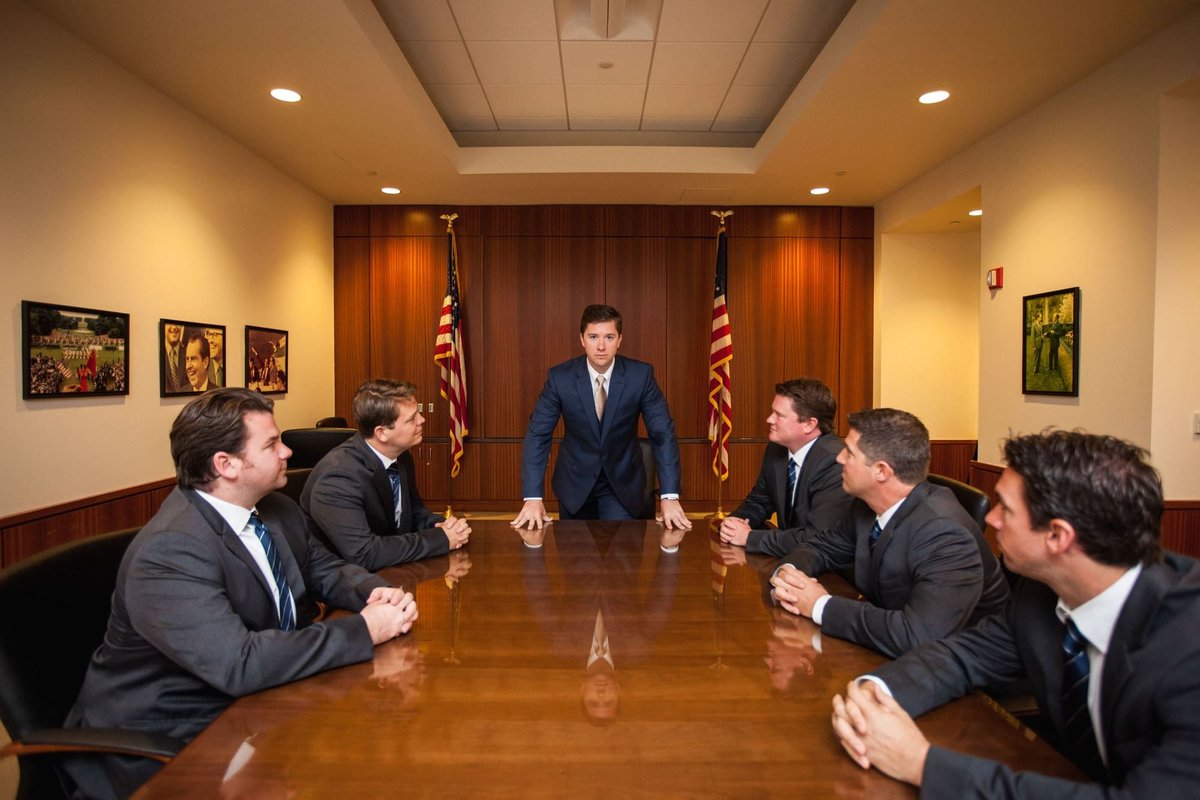 Groom and his Groomsmen having fun posing for a presidential meeting before the wedding