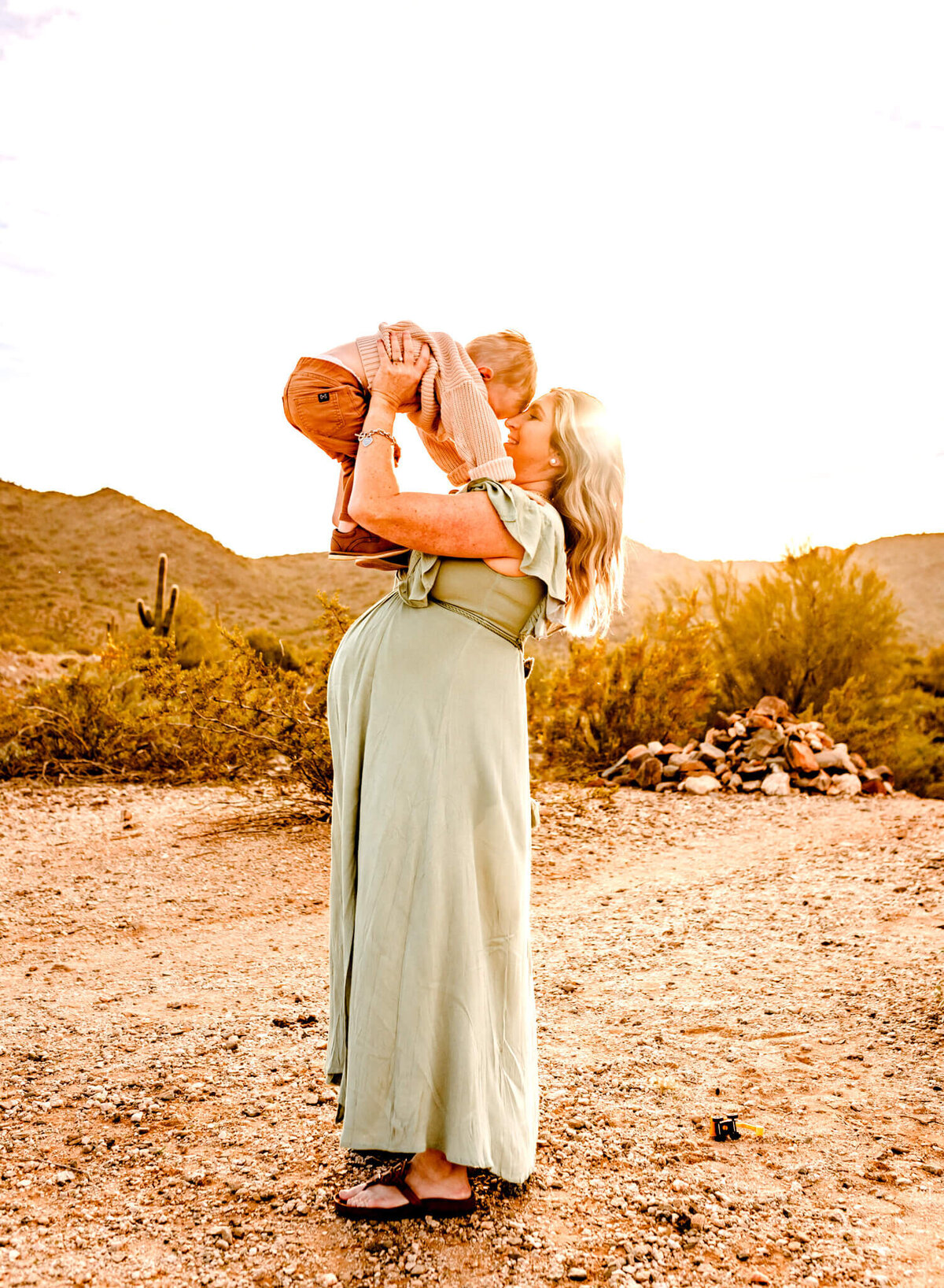 photograph of mom holding her son to her forehead during maternity portraits in Arizona