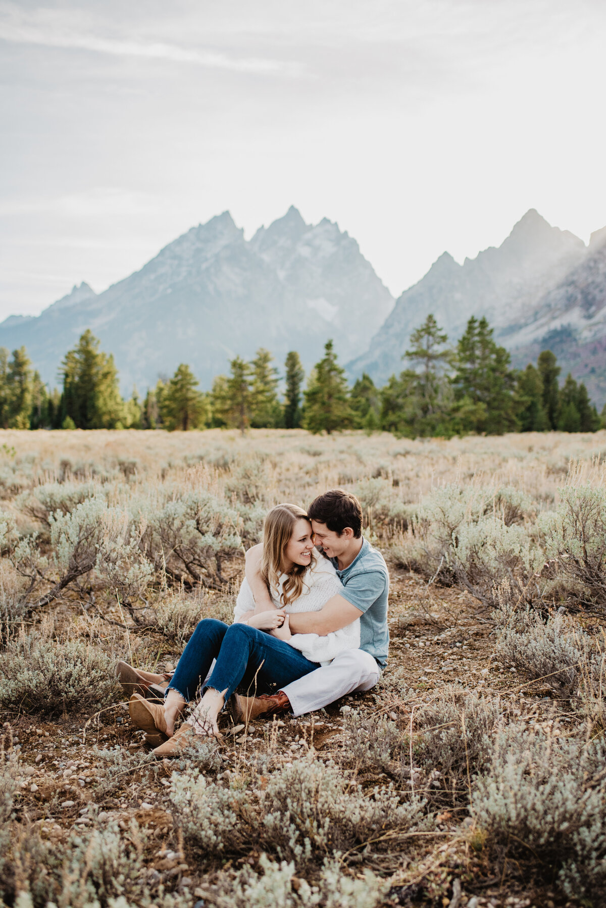 Photographers Jackson Hole capture couple sitting together during fall engagements