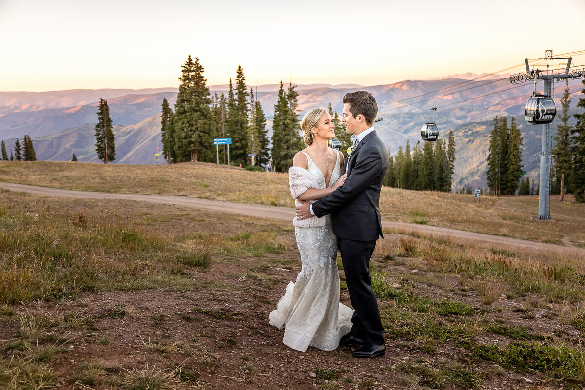Bride and Groom Embrace on the top of Aspen