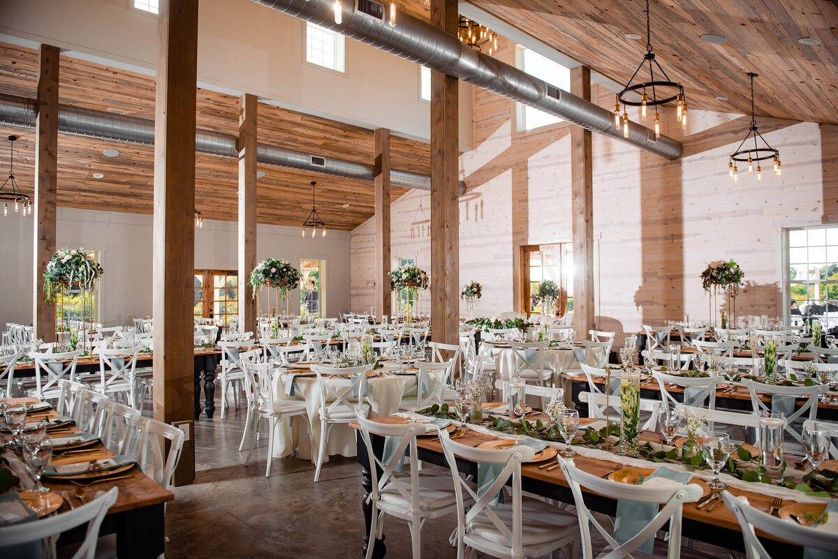 Large photo of reception space at indoor white barn
