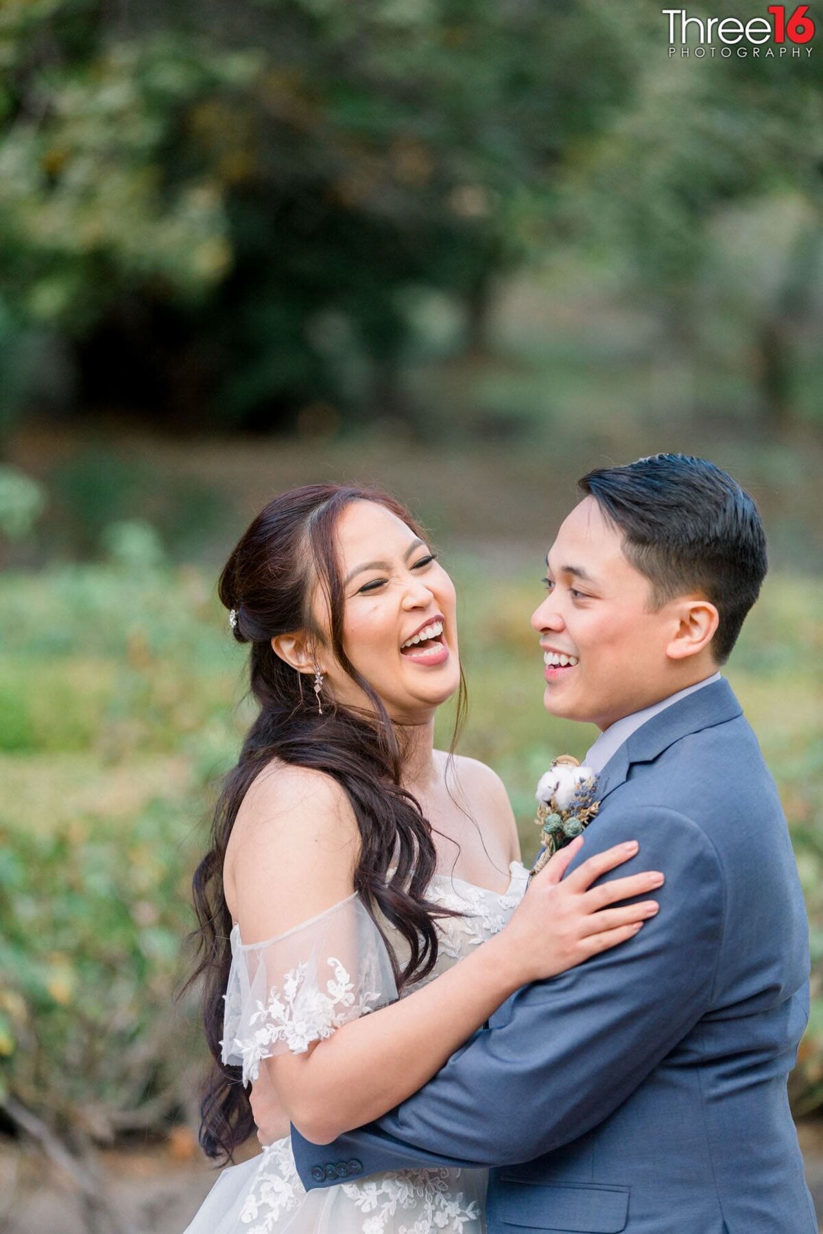 Bride begins to laugh as her and her Groom embrace each other
