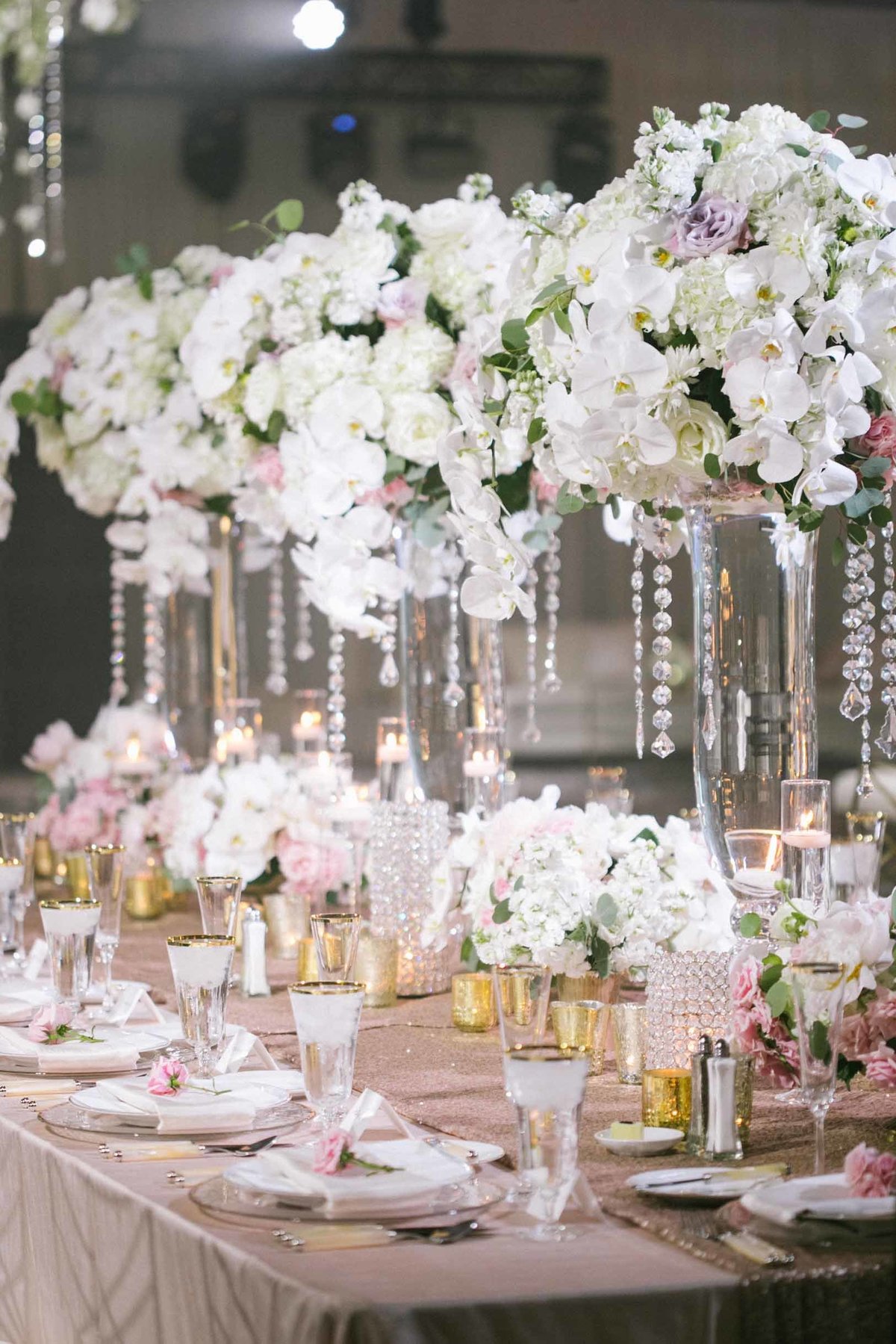 Grand head table lined with tall white  orchid  arrangements flora nova design Seattle